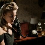 photo of woman in black off shoulder dress