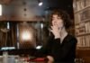 woman in black long sleeve smoking cigarette